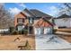 Brick two-story house with a two-car garage and landscaped yard at 2885 Field Spring Dr, Lithonia, GA 30058