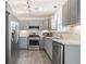 Modern kitchen with gray cabinets, granite counters, and stainless steel appliances at 2885 Field Spring Dr, Lithonia, GA 30058