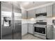Modern kitchen with gray cabinets, granite counters, and stainless steel appliances at 2885 Field Spring Dr, Lithonia, GA 30058