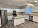 Modern kitchen with white cabinets, granite countertops, and stainless steel appliances at 3030 Parkland Vw, Atlanta, GA 30331