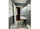 Bathroom features pedestal sink, window, and view into the hallway at 5409 Mill Valley Dr, Douglasville, GA 30135