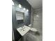 Bathroom features pedestal sink and marble-look tile in the shower at 5409 Mill Valley Dr, Douglasville, GA 30135