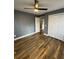 Bedroom featuring dark grey walls and wood laminate flooring, with a ceiling fan and closet at 5409 Mill Valley Dr, Douglasville, GA 30135