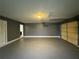 Large two car garage has concrete flooring and is illuminated by an overhead light at 5409 Mill Valley Dr, Douglasville, GA 30135