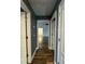 Hallway with dark wood floors leads into the open living area with a ceiling fan at 5409 Mill Valley Dr, Douglasville, GA 30135