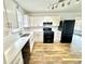 Updated kitchen featuring white cabinets, stainless steel sink and black appliances at 5409 Mill Valley Dr, Douglasville, GA 30135