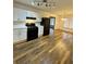 View of kitchen including black appliances, white cabinets, countertop and dining area at 5409 Mill Valley Dr, Douglasville, GA 30135