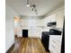 Bright kitchen features white cabinets, black appliances, and wood-look flooring at 5409 Mill Valley Dr, Douglasville, GA 30135