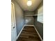 A simple laundry room with utility connections, shelving, and one window at 5409 Mill Valley Dr, Douglasville, GA 30135