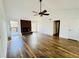 Living room featuring vaulted ceilings, fireplace, exterior doors, and wood-look flooring at 5409 Mill Valley Dr, Douglasville, GA 30135