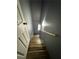 A wood staircase is adjacent to a gray wall and wood handrail at 5409 Mill Valley Dr, Douglasville, GA 30135