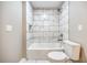 White tiled tub and shower combination with modern fixtures and toilet at 1449 Athens Sw Ave, Atlanta, GA 30310