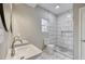 A bathroom features a white marble shower and double sinks at 1449 Athens Sw Ave, Atlanta, GA 30310