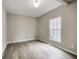 A bright bedroom features wood-look flooring and a large window at 1449 Athens Sw Ave, Atlanta, GA 30310