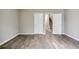 A spacious bedroom features wood-look flooring and two doors at 1449 Athens Sw Ave, Atlanta, GA 30310