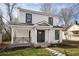Charming two-story home with white siding, black framed windows, and a cozy front porch at 1449 Athens Sw Ave, Atlanta, GA 30310