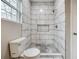 A walk-in shower features white marble tile and a shower niche at 1449 Athens Sw Ave, Atlanta, GA 30310