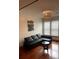 Living room with leather sectional sofa, wood floors, and large windows at 898 Oak St # 3423, Atlanta, GA 30310