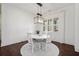 Bright dining room features a white table and chairs, hardwood floors, and shiplap walls at 113 Brookfield Se Ct, White, GA 30184