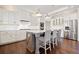 Kitchen island with seating, stainless steel appliances, and hardwood floors at 113 Brookfield Se Ct, White, GA 30184