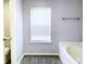 Bathroom with soaking tub and grey tile flooring at 4534 Parkway Cir, Atlanta, GA 30349