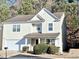 Two-story house with light beige siding, a double garage, and manicured landscaping at 4534 Parkway Cir, Atlanta, GA 30349