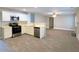 Modern eat-in kitchen with white cabinets, stainless steel appliances, and wood-look tile floors at 4534 Parkway Cir, Atlanta, GA 30349