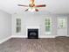Living room with fireplace, wood-look floors, and ceiling fan at 4534 Parkway Cir, Atlanta, GA 30349