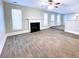 Spacious living room with wood-look tile flooring, fireplace, and ceiling fan at 4534 Parkway Cir, Atlanta, GA 30349