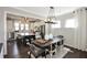 Dining area with dark wood table, chairs, and an open view to kitchen at 5759 Grapewood St, Hoschton, GA 30548