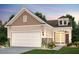 Two-story home with beige siding, white garage door, and stone accents at 5759 Grapewood St, Hoschton, GA 30548