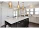 Kitchen island with white quartz countertop and dark lower cabinets at 5759 Grapewood St, Hoschton, GA 30548