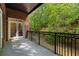 A lovely brick balcony with wrought iron and view of the surrounding wooded area at 3280 Stillhouse Se Ln # 305, Atlanta, GA 30339