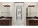 Dual vanity bathroom with granite countertops and large mirrors with view to bedroom at 3280 Stillhouse Se Ln # 305, Atlanta, GA 30339