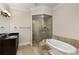 Bathroom featuring a shower with glass door, soaking tub and granite countertops at 3280 Stillhouse Se Ln # 305, Atlanta, GA 30339