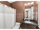 Bathroom featuring dark vanity with granite countertop and shower with curtain at 3280 Stillhouse Se Ln # 305, Atlanta, GA 30339