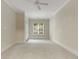 Bright bedroom with neutral carpet, ceiling fan, large window bringing in natural light, and white trim at 3280 Stillhouse Se Ln # 305, Atlanta, GA 30339