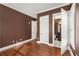Bedroom with hardwood floors and brown paint, door leading to bathroom at 3280 Stillhouse Se Ln # 305, Atlanta, GA 30339