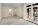 Bedroom with neutral carpet and trim, ceiling fan and french doors leading to a balcony at 3280 Stillhouse Se Ln # 305, Atlanta, GA 30339