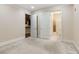 Spacious bedroom featuring openings to the bathroom and kitchen, carpeted flooring, and a neutral color palette at 3280 Stillhouse Se Ln # 305, Atlanta, GA 30339