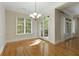 Light-filled dining room featuring hardwood floors, a chandelier, and views of the outdoors at 3280 Stillhouse Se Ln # 305, Atlanta, GA 30339
