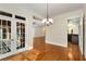 Elegant dining area with hardwood floors and French doors, flowing seamlessly into the kitchen at 3280 Stillhouse Se Ln # 305, Atlanta, GA 30339
