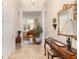 Elegant foyer with tiled floor, chandelier, columns, piano, and ornate mirror creating a grand entrance at 3280 Stillhouse Se Ln # 305, Atlanta, GA 30339