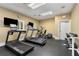 Well-equipped gym with modern treadmills, elliptical machine, weights, and wall-mounted TVs at 3280 Stillhouse Se Ln # 305, Atlanta, GA 30339