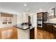 Spacious kitchen with dark cabinets, stainless steel appliances, granite countertops, and hardwood floors at 3280 Stillhouse Se Ln # 305, Atlanta, GA 30339