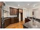 Well-lit open kitchen featuring stainless steel appliances and dark wood cabinetry at 3280 Stillhouse Se Ln # 305, Atlanta, GA 30339