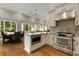Spacious kitchen features stainless steel appliances, granite countertops, and a large island at 3280 Stillhouse Se Ln # 305, Atlanta, GA 30339
