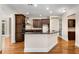 Bright kitchen with dark cabinets, stainless steel appliances, granite countertops, and wood floors at 3280 Stillhouse Se Ln # 305, Atlanta, GA 30339