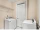 Bright laundry room with a modern washer and dryer set, storage, and tile flooring at 3280 Stillhouse Se Ln # 305, Atlanta, GA 30339