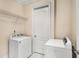 Laundry room with white washer, dryer and wire shelving at 3280 Stillhouse Se Ln # 305, Atlanta, GA 30339